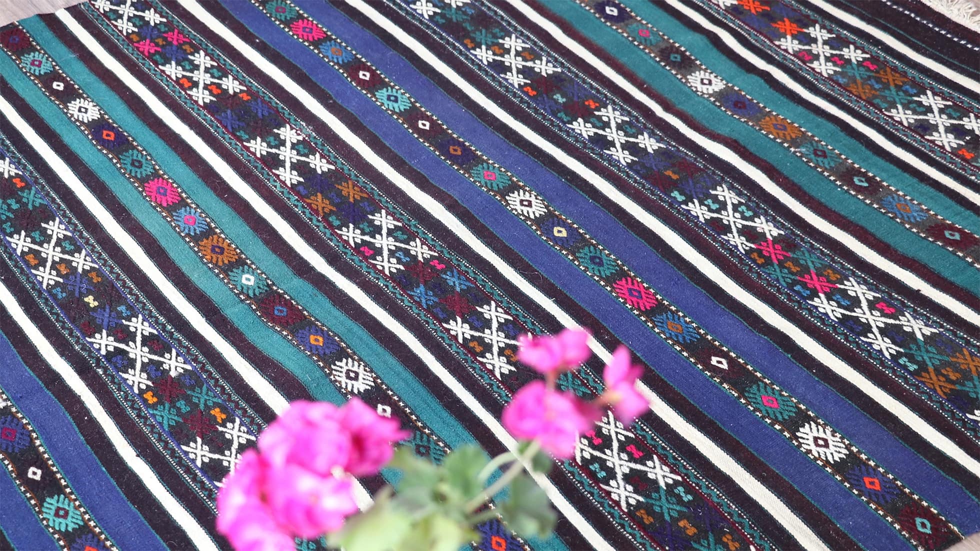 details of mid-century geometric vintage kilim rug with black and white stripes