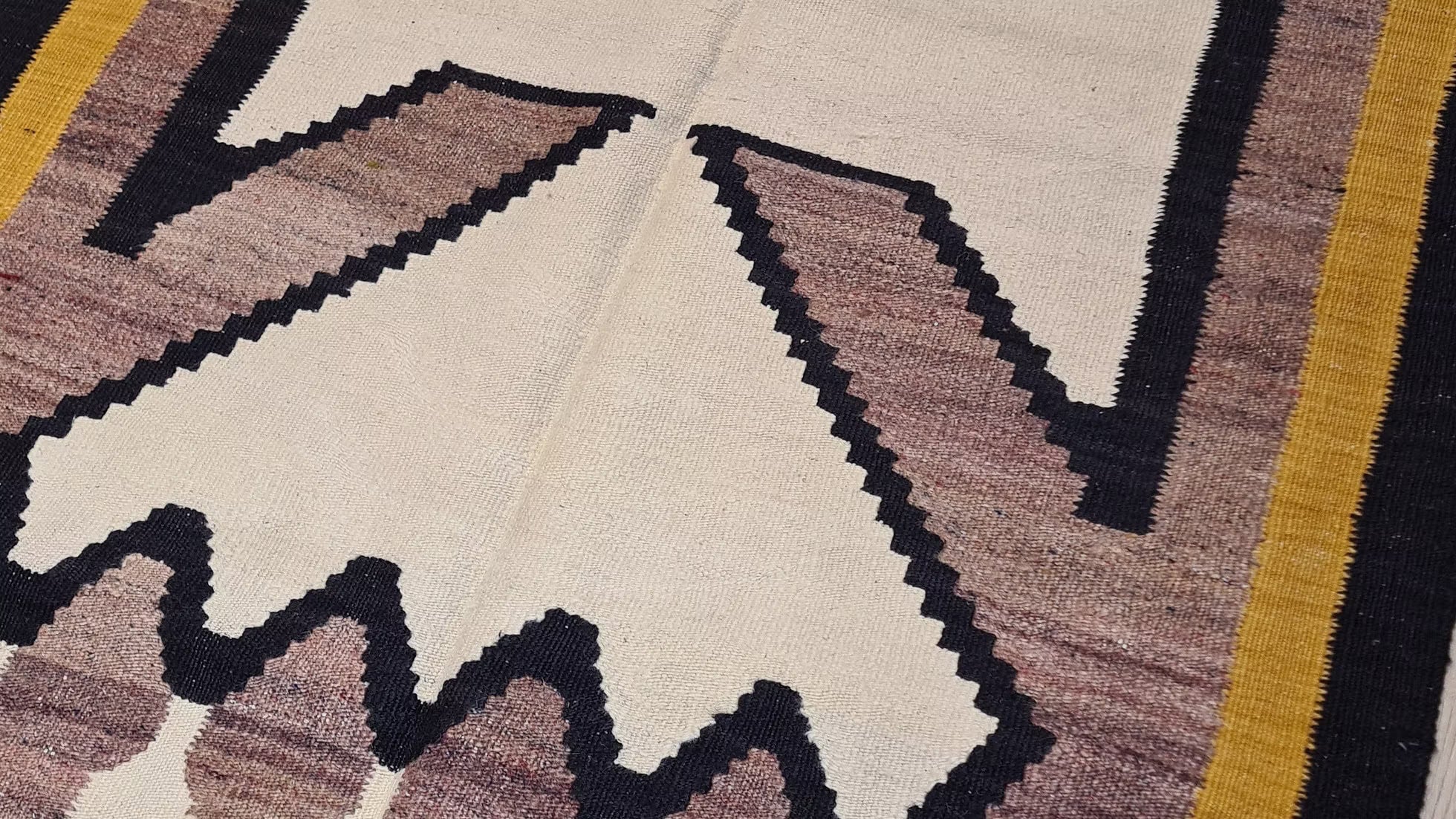 Contemporary handwoven Oushak rug with a simplified geometric figure and vibrant saffron gold accents.