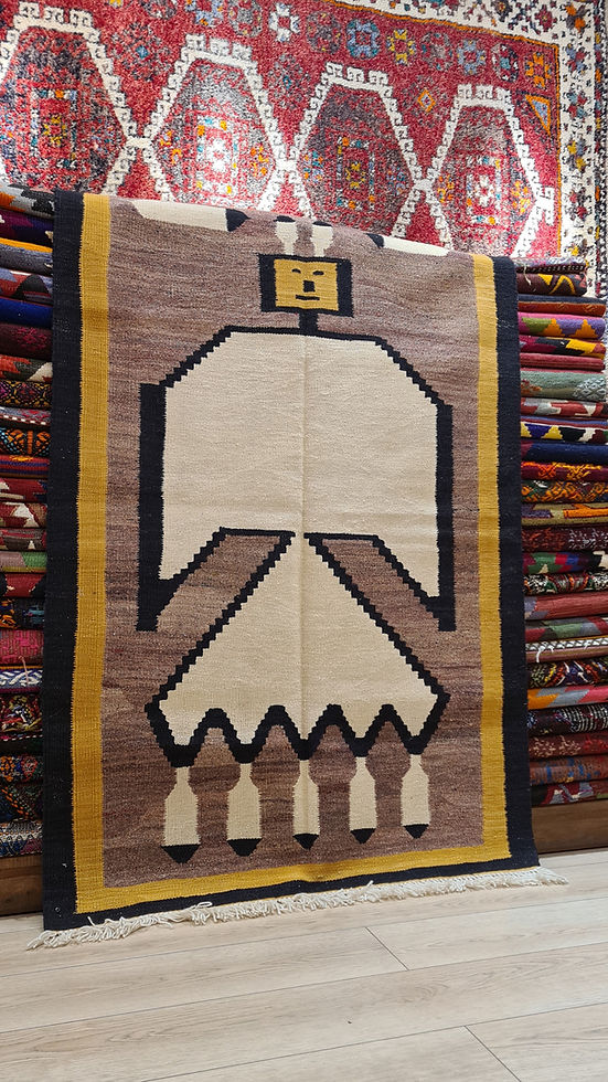 Contemporary Turkish kilim rug featuring modernist tribal motifs in saffron gold and black.