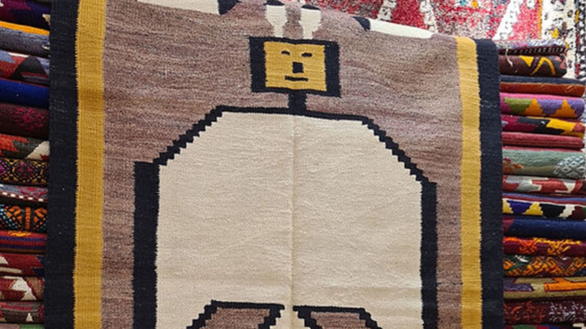 Handwoven Turkish Oushak rug with abstract geometric design in desert taupe, ecru, and onyx black.