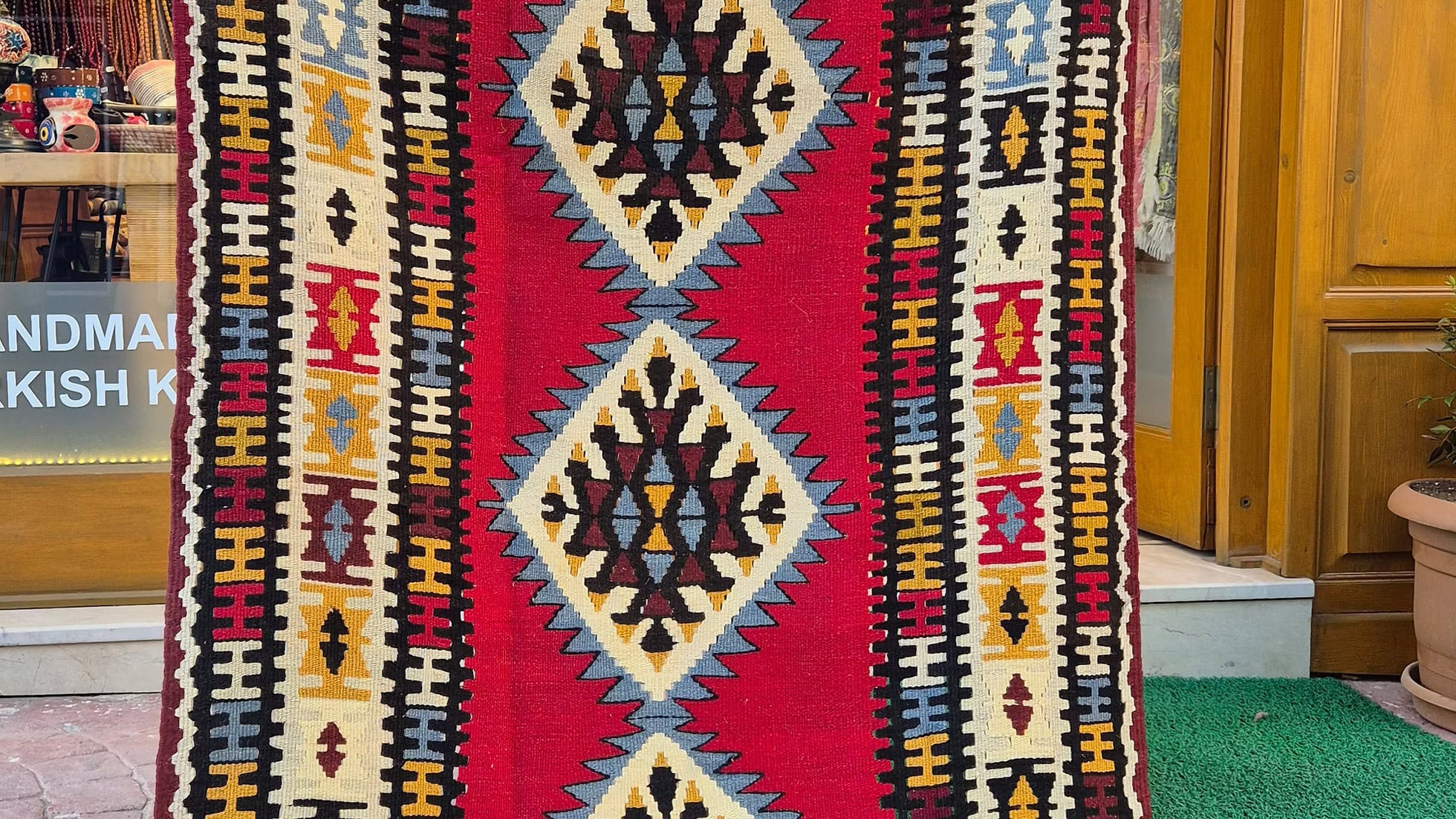 Handwoven Uşak Oushak Kilim rug in crimson red and denim blue by Kilim Couture New York