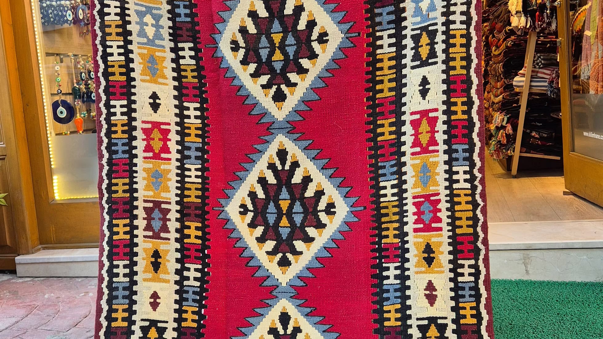 Authentic Anatolian handwoven rug with triple borders and tribaş motifs, perfect for modern and rustic interiors