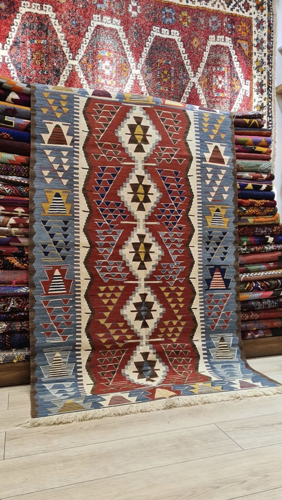 Handwoven patterned Oushak rug with geometric designs in red, ivory and blue colors.