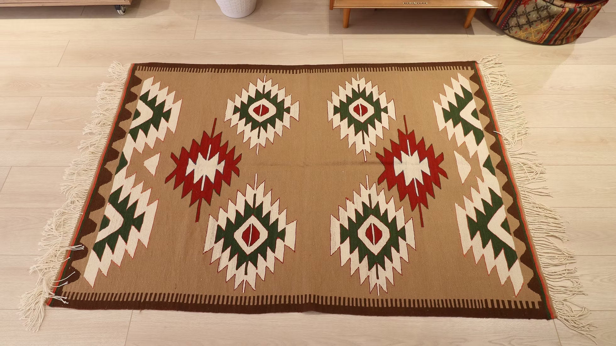 Decorative navajo style modern rug with geometric lozenge pattern on a wooden floor