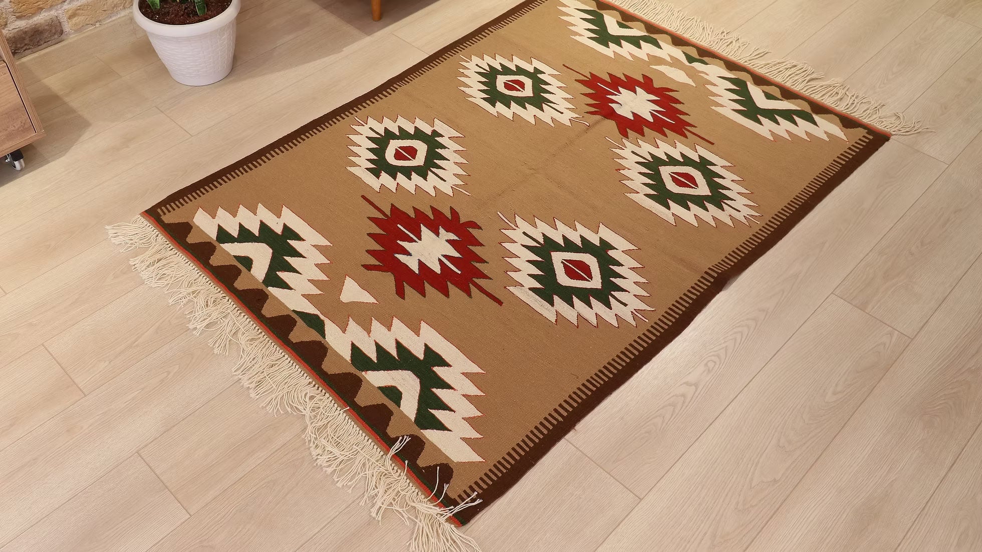 Flat-weave Oushak kilim rug featuring geometric lozenges and a sophisticated color palette, perfect for interior designers and set decorators.