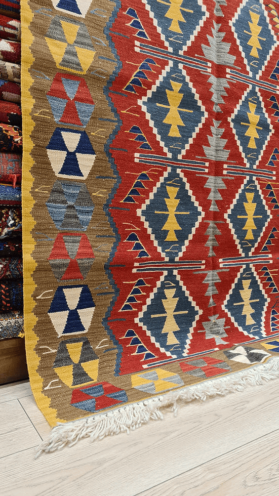 Textured flat-weave Oushak Kilim rug from Kilim Couture New York showcasing tribal-inspired design