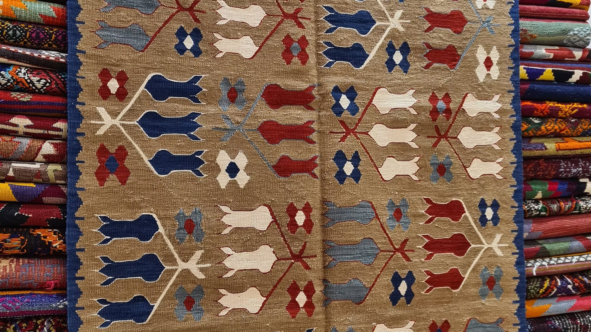 Close-up view of the tulip design on a contemporary Turkish handwoven Oushak kilim rug from Kilim Couture NYC, featuring luxurious hues perfect for NYC luxury apartments and modern Brooklyn lofts.