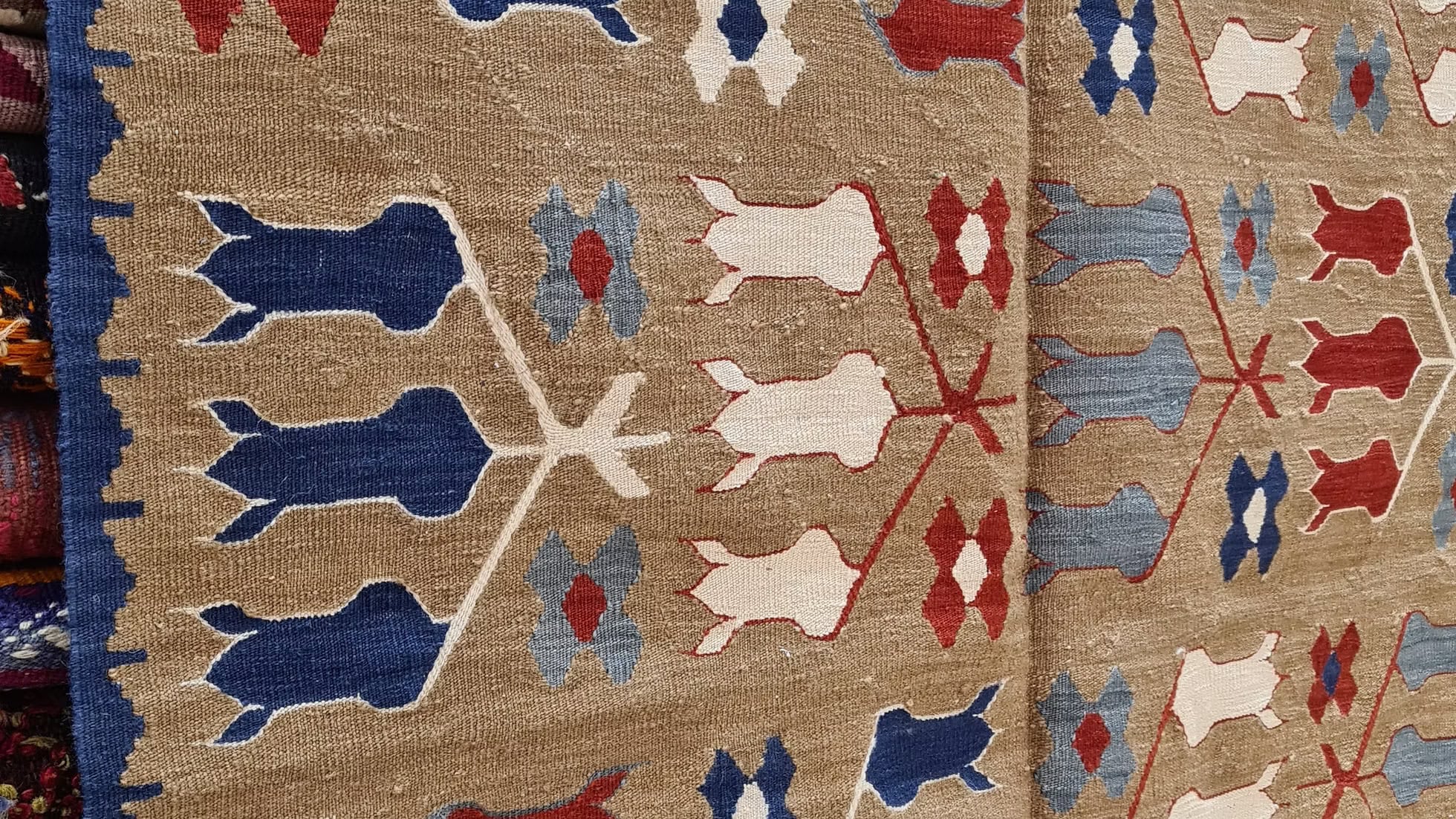 Side angle of a Turkish Oushak kilim rug from Kilim Couture NYC, showcasing its intricate tulip design—perfect for upscale Brooklyn lofts or high-end NYC apartments.