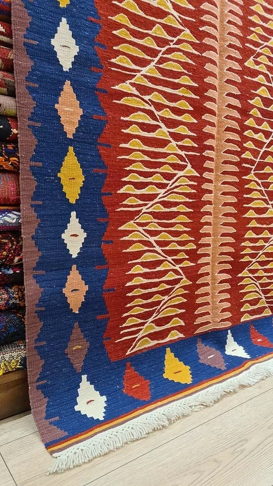 Modern Oushak kilim with geometric saffron motifs and navy border, Turkish artisan rug for interior designers