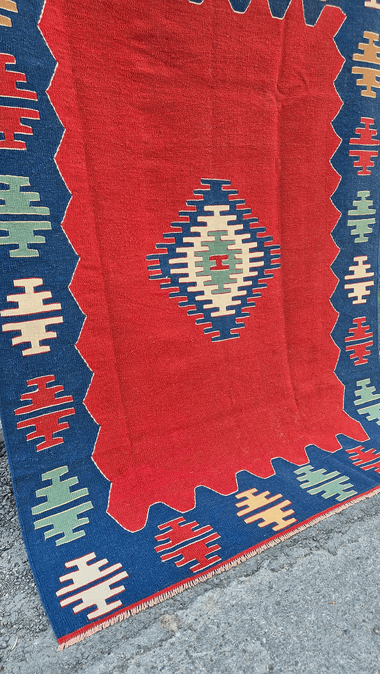 Modern minimalist kilim rug from Kilim Couture New York featuring tribal motifs in deep vermillion and midnight blue tones