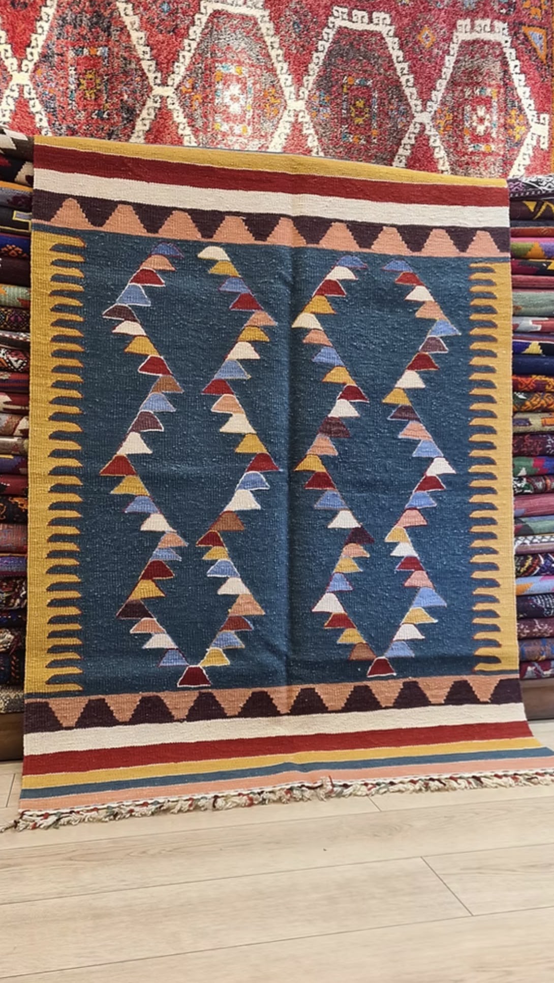 Turkish oushak flat-weave with geometric pattern featuring triangles on a blue background