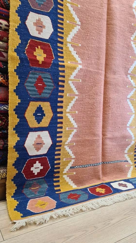 Contemporary Usak kilim rug with Nordic-inspired minimalism, woven in salmon tones with refined border motifs