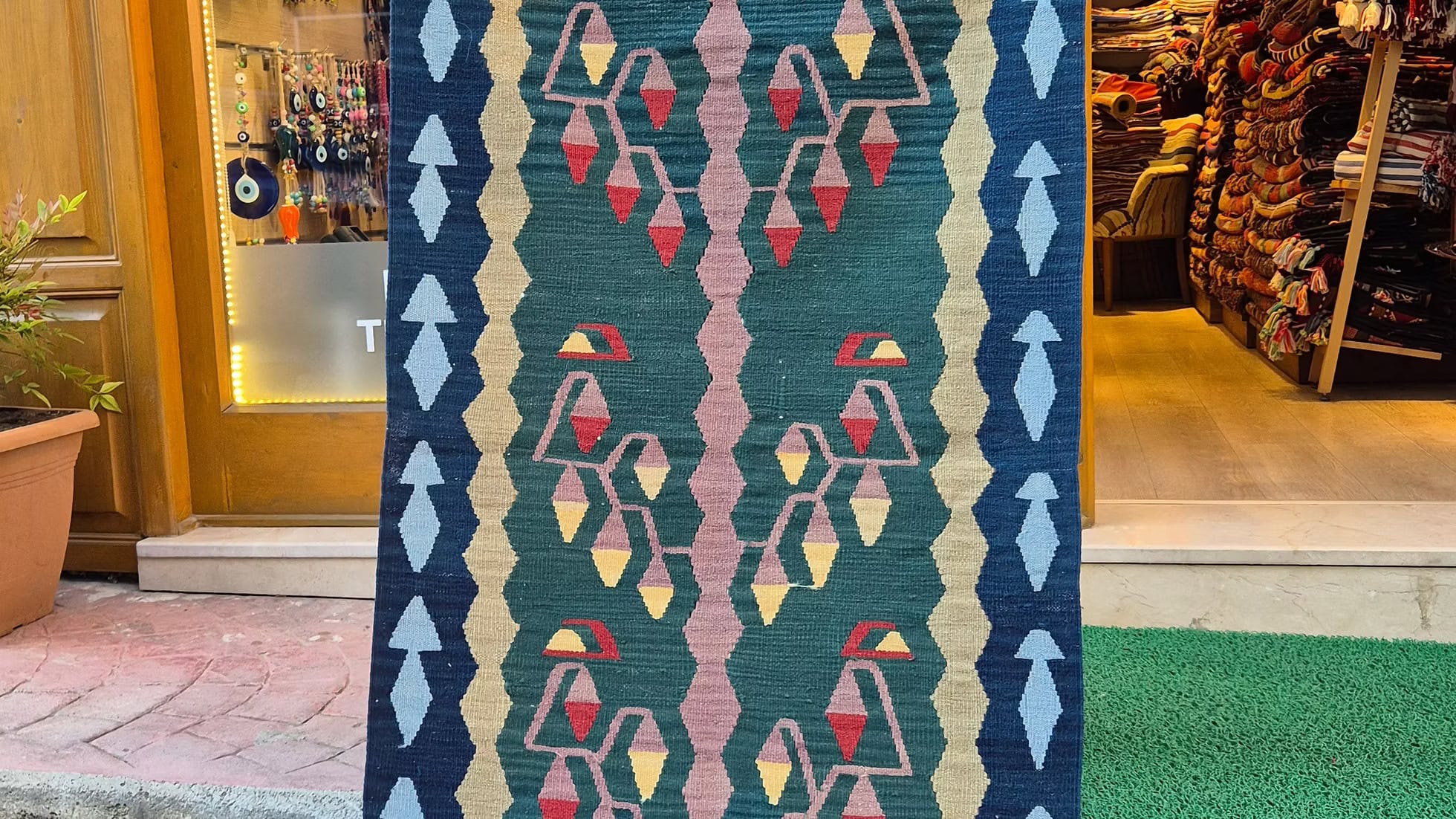 Pastel-colored Turkish handwoven rug runner showcasing intricate life-of-tree and flower motifs