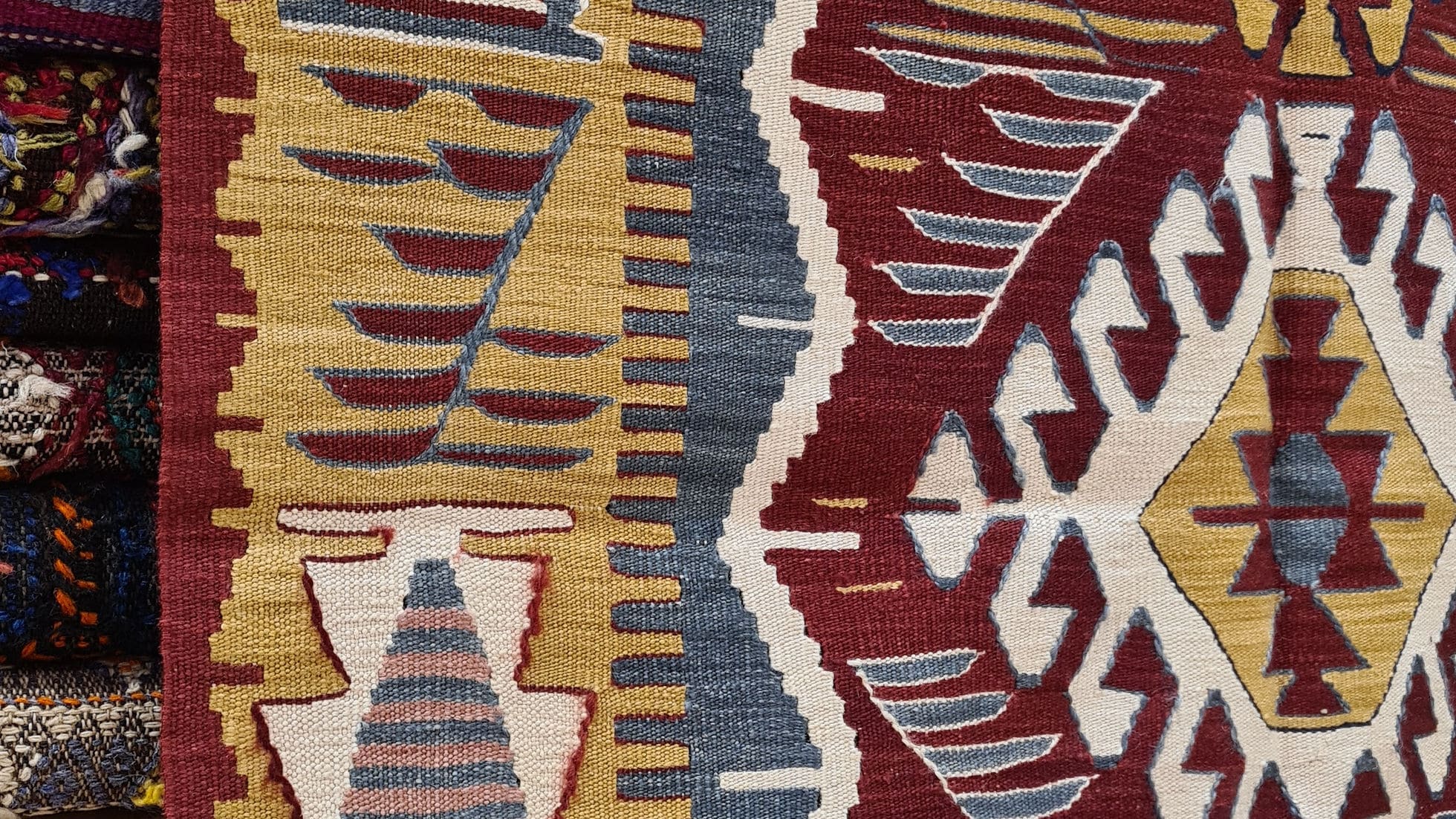 Detailed close-up of the Oushak flat-woven geometric rug with intricate dragon medallions.