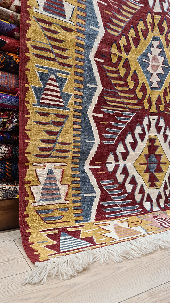 Textured close-up of the flat-woven rug with a cool blue limestone and warm mustard border.
