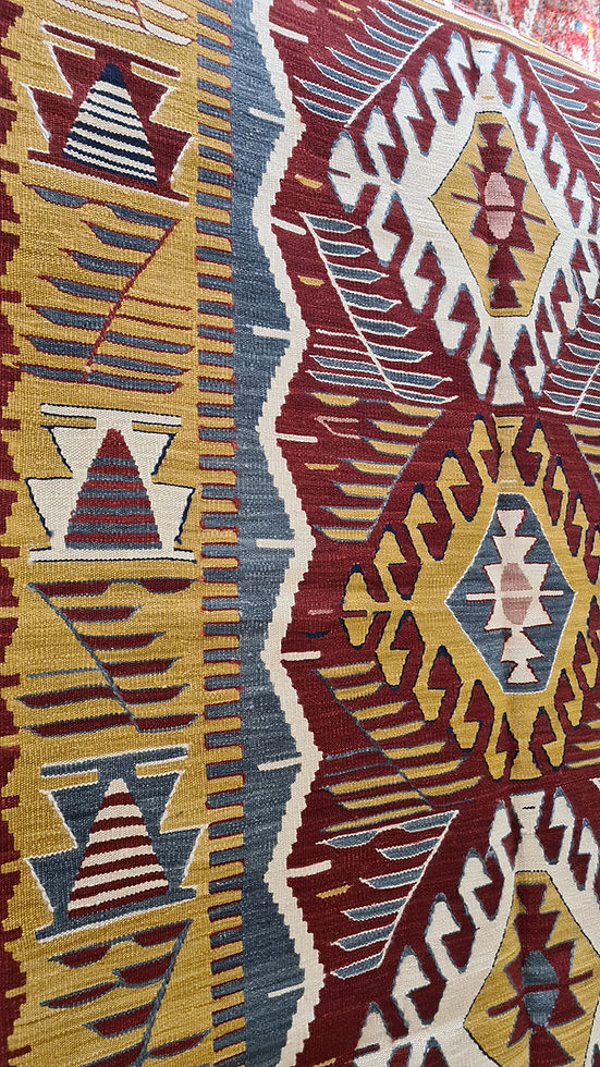 Traditional Anatolian motifs reinterpreted in a modern design on a Turkish handwoven rug by Kilim Couture NYC Rug Store.