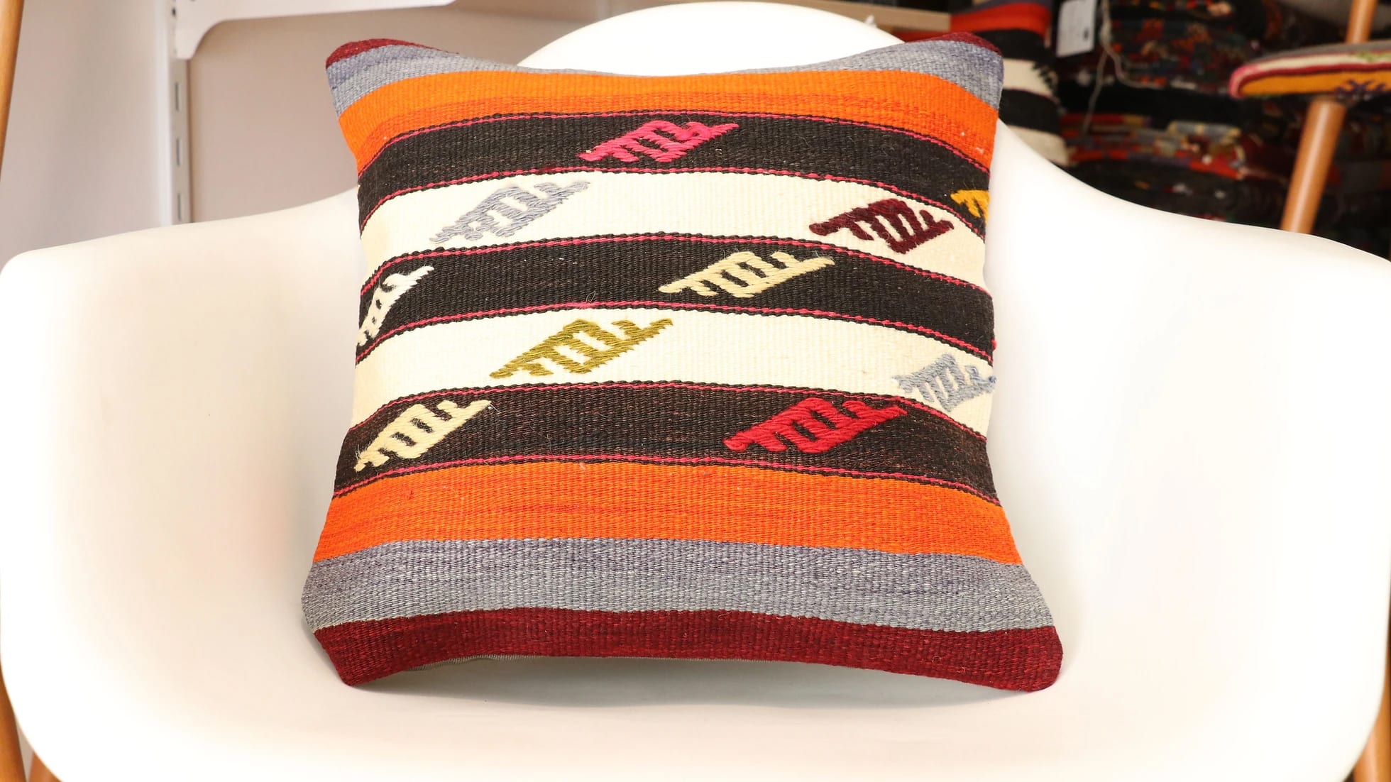 vintage kilim upholstered pillow cover made of mid-century wool rugs in vibrant colors