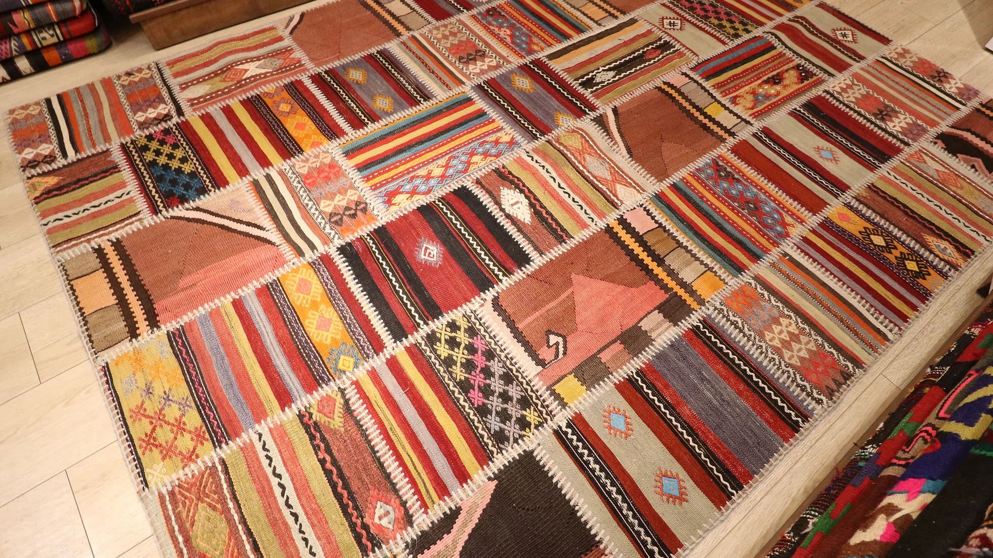 meticulously handwoven semi-antique patchwork rug made of different antique Turkish carpet fragments