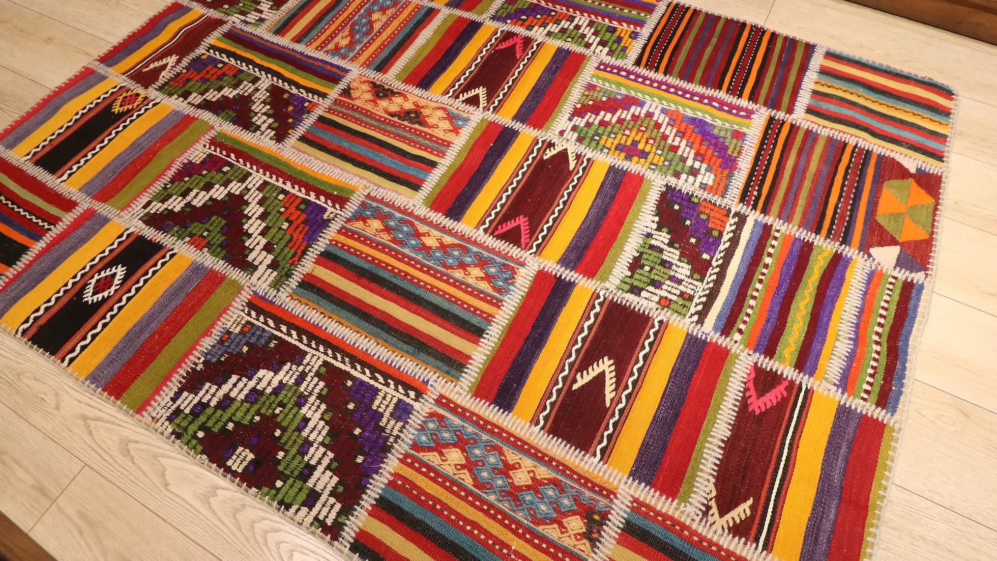 Bold Tribal Motifs and Rich Color Palette of a Turkish Kilim Rug in Patchwork Design