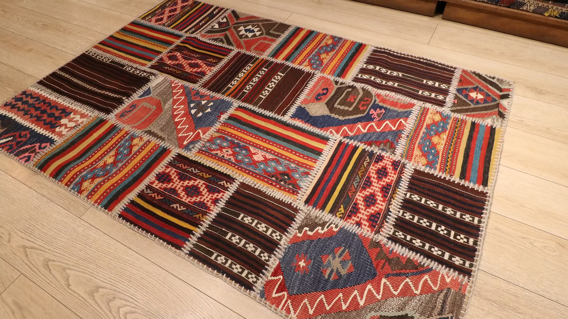 Multicolored patchwork area rug with geometric patterns