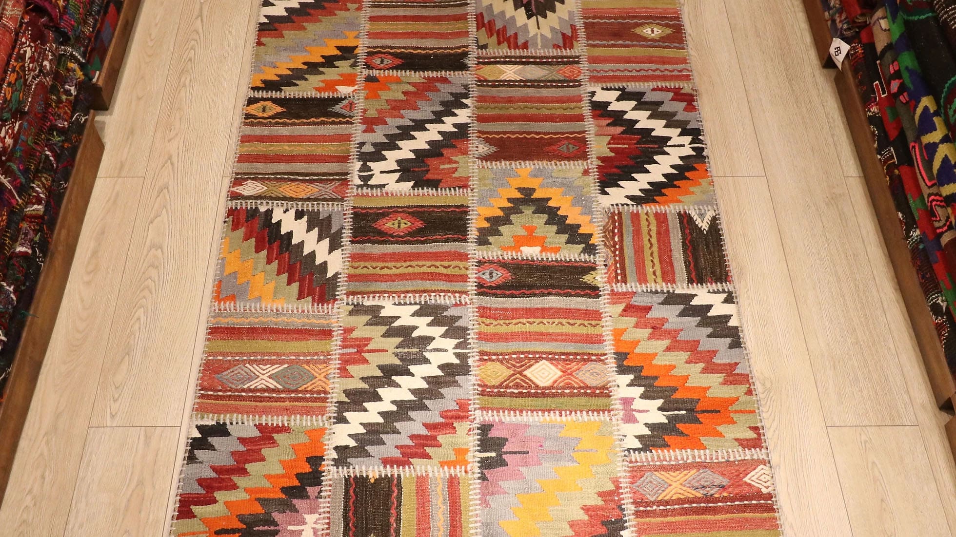 a beautiful and precious semi-antique tribal patchwork flat-weave rug in muted and faded hues in geometric stripes