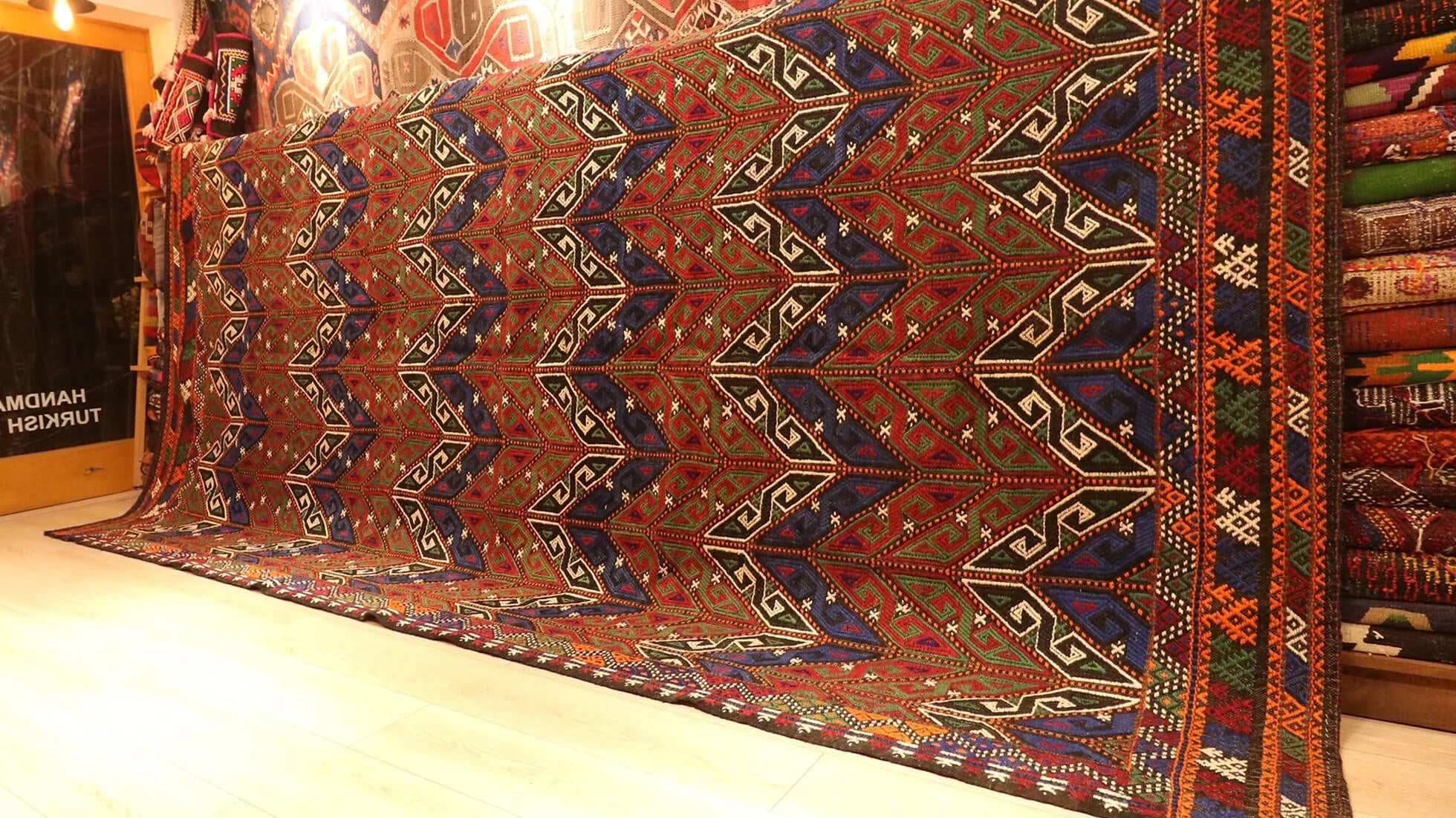 a beautiful yet precious room-sized oversize tribal Turkish rug in faded rustic tones featuring traditional Turkish motifs
