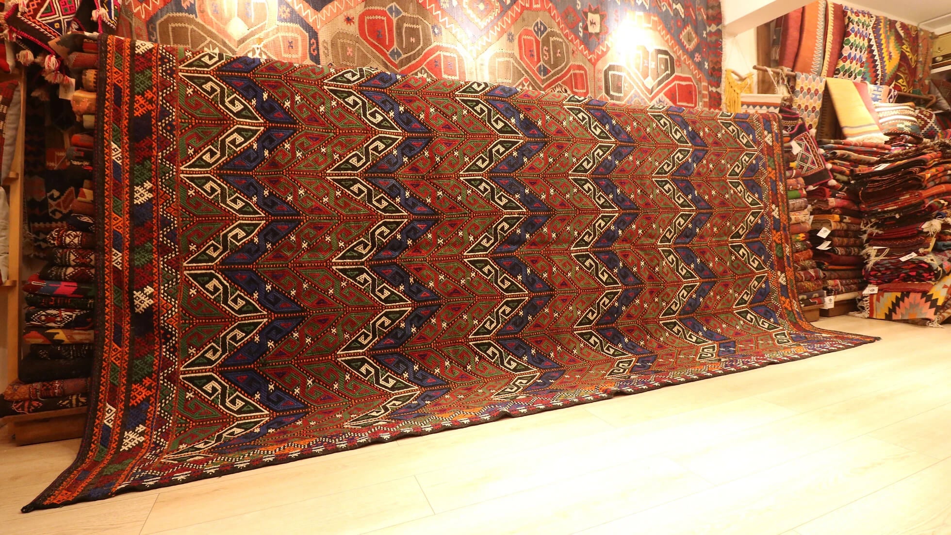 a beautiful yet precious room-sized oversize tribal Turkish rug in faded rustic tones featuring traditional Turkish motifs