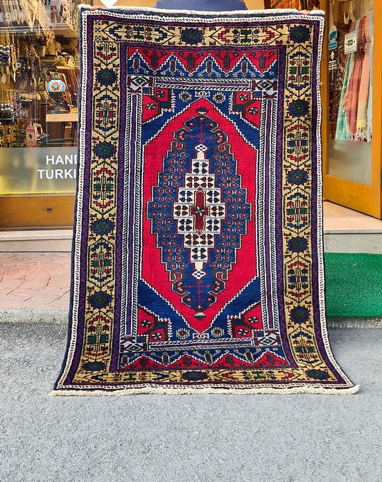 Hand-knotted in Taspinar, Turkey, this semi-antique 4x6 ft rug features a striking medallion with intricate floral patterns in crimson, gold, and azure. Made from pure wool and dyed with natural pigments, it offers unmatched durability and elegance. Perfect for hallways, entryways, or kitchens, this rug blends Anatolian heritage with timeless design.