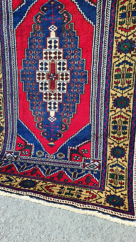 Hand-knotted in Taspinar, Turkey, this semi-antique 4x6 ft rug features a striking medallion with intricate floral patterns in crimson, gold, and azure. Made from pure wool and dyed with natural pigments, it offers unmatched durability and elegance. Perfect for hallways, entryways, or kitchens, this rug blends Anatolian heritage with timeless design.