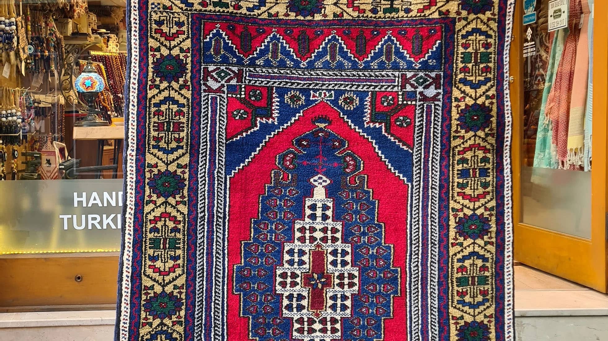 Hand-knotted in Taspinar, Turkey, this semi-antique 4x6 ft rug features a striking medallion with intricate floral patterns in crimson, gold, and azure. Made from pure wool and dyed with natural pigments, it offers unmatched durability and elegance. Perfect for hallways, entryways, or kitchens, this rug blends Anatolian heritage with timeless design.