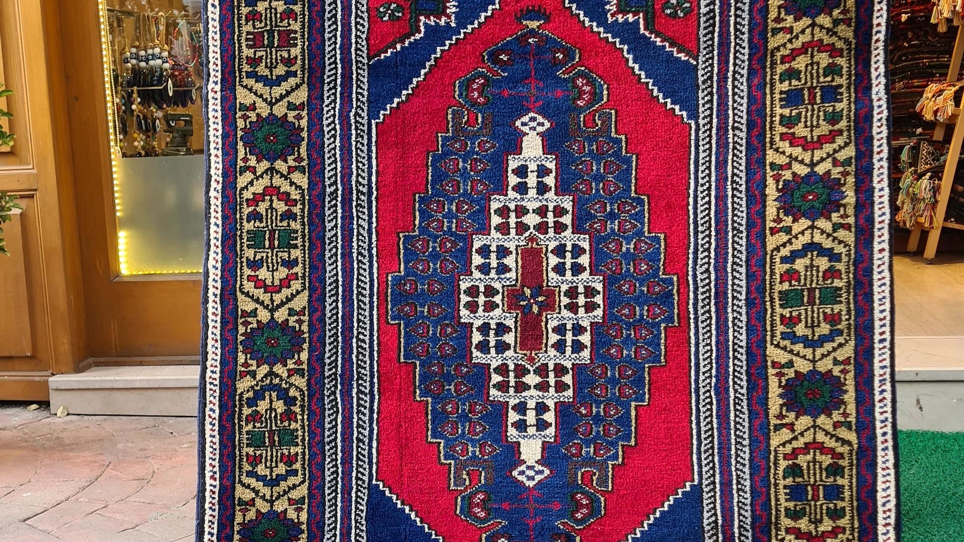 Hand-knotted in Taspinar, Turkey, this semi-antique 4x6 ft rug features a striking medallion with intricate floral patterns in crimson, gold, and azure. Made from pure wool and dyed with natural pigments, it offers unmatched durability and elegance. Perfect for hallways, entryways, or kitchens, this rug blends Anatolian heritage with timeless design.