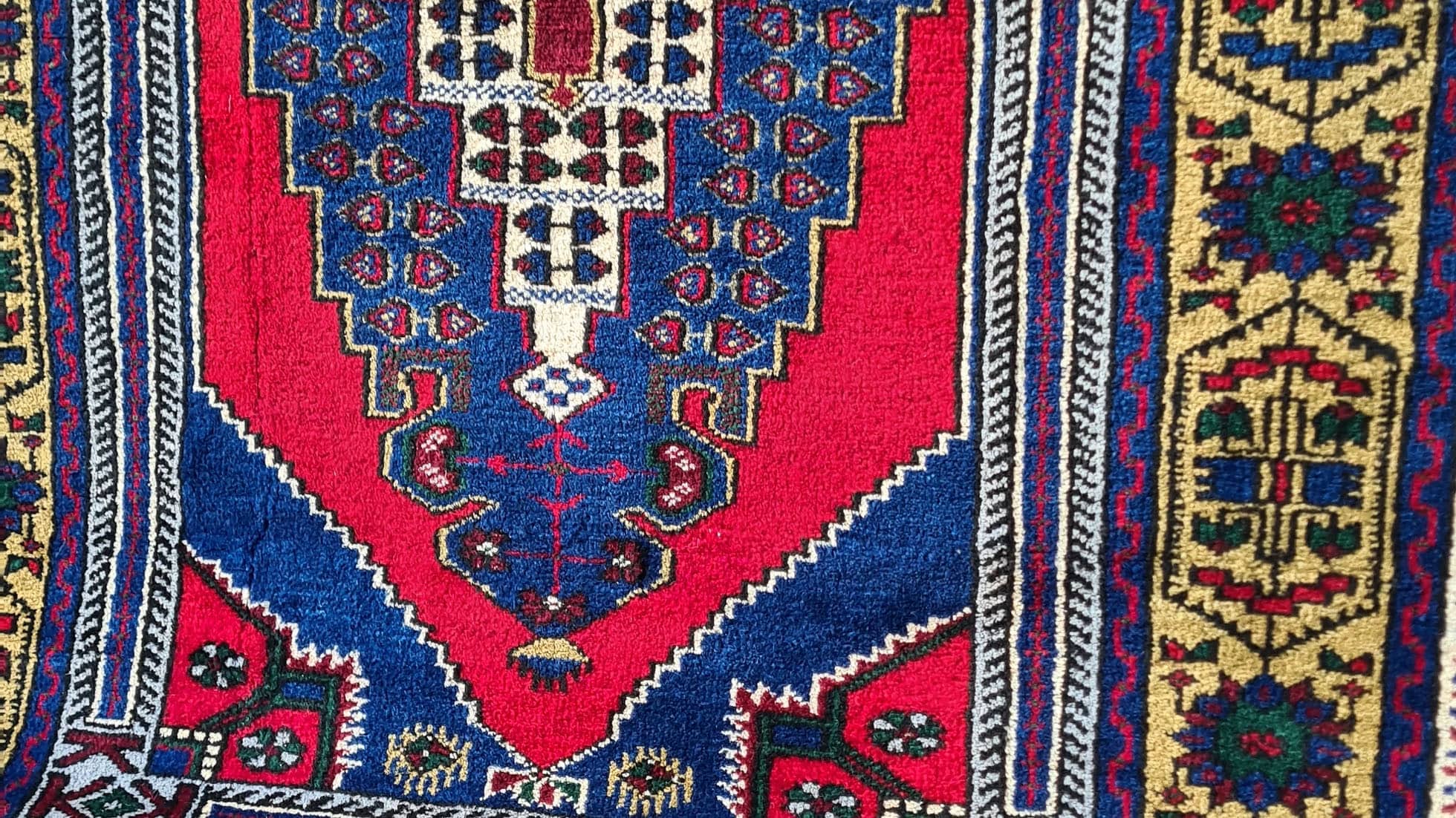 Hand-knotted in Taspinar, Turkey, this semi-antique 4x6 ft rug features a striking medallion with intricate floral patterns in crimson, gold, and azure. Made from pure wool and dyed with natural pigments, it offers unmatched durability and elegance. Perfect for hallways, entryways, or kitchens, this rug blends Anatolian heritage with timeless design.