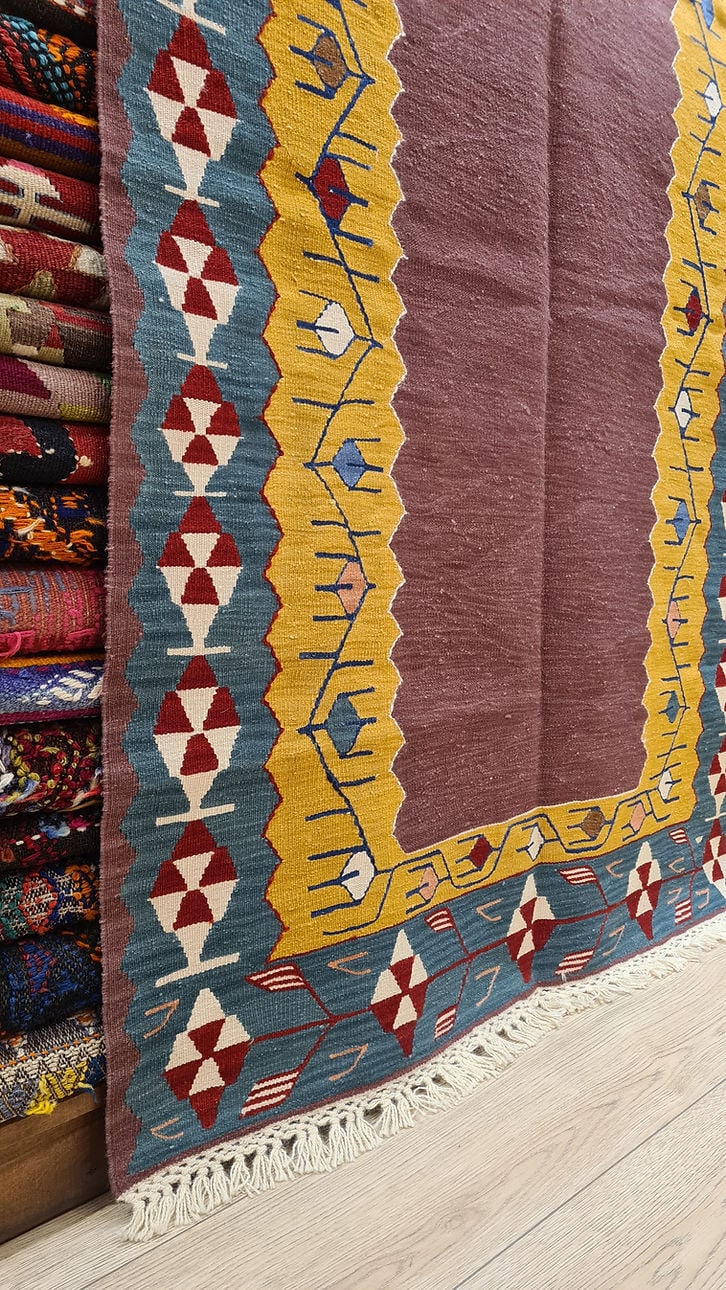 Exquisite Turkish Usak kilim rug in muted Dusty Plum, Soft Dijon, and deep Denim Blue for a timeless look.