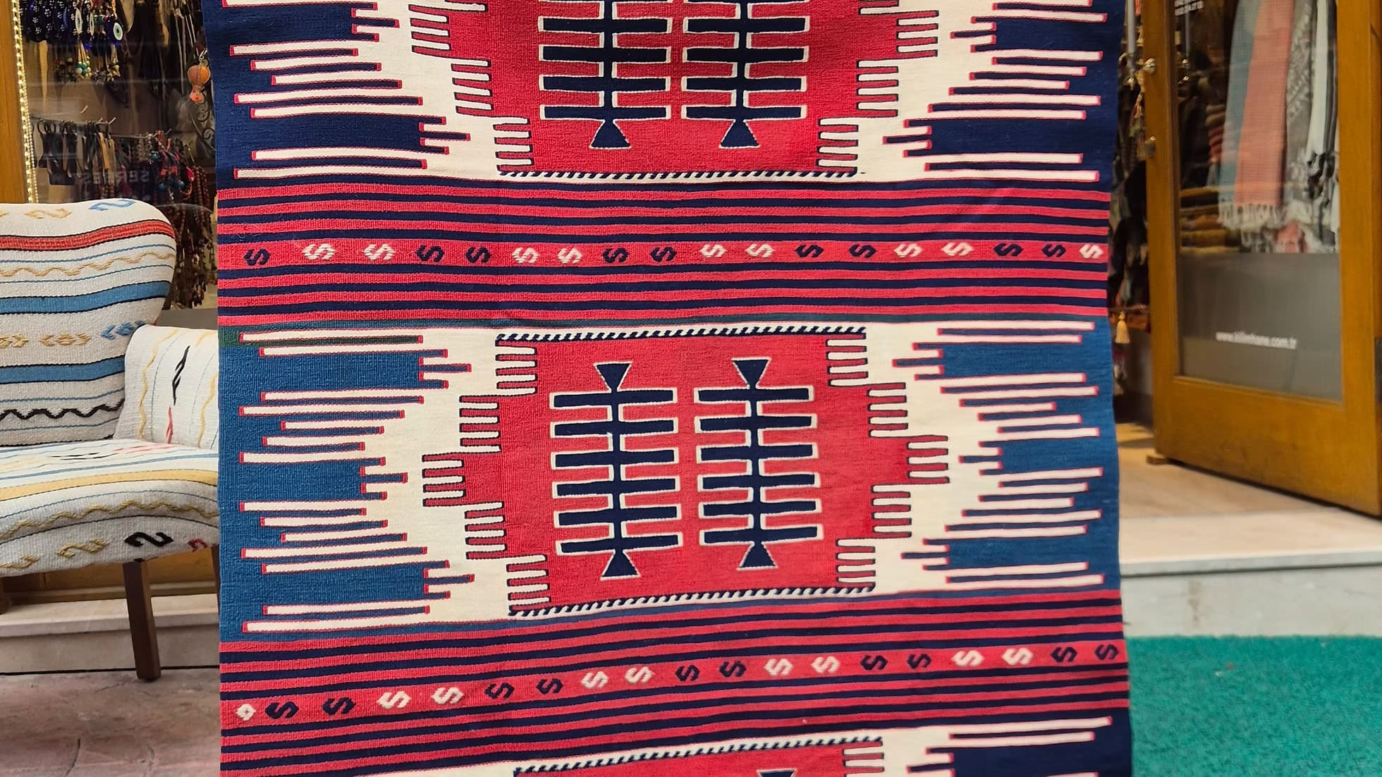 One-of-a-kind handwoven Navajo rug in red and blue with stripes