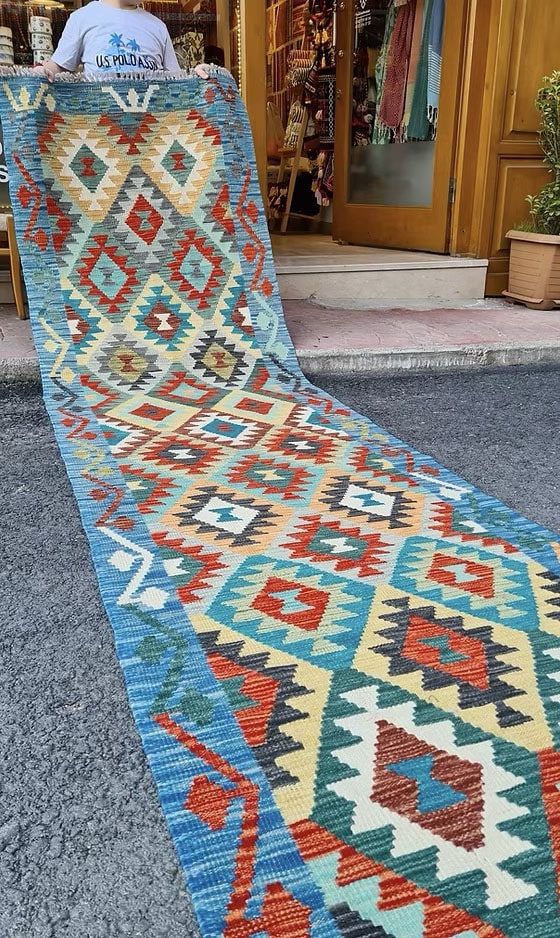 Vintage Afghan handwoven runner with coastal diamond flat-weave design in blue, gray, ivory, and red accents for modern and coastal interiors.