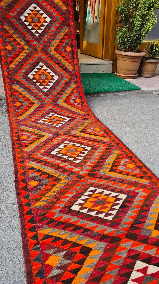 Artisan-made Afghan runner, 3x12 ft, featuring a bold diamond flat-weave design in vermilion red, persimmon orange, and ochre yellow. Durable and versatile, ideal for hallways, kitchens, or entryways, blending tradition with modern style.