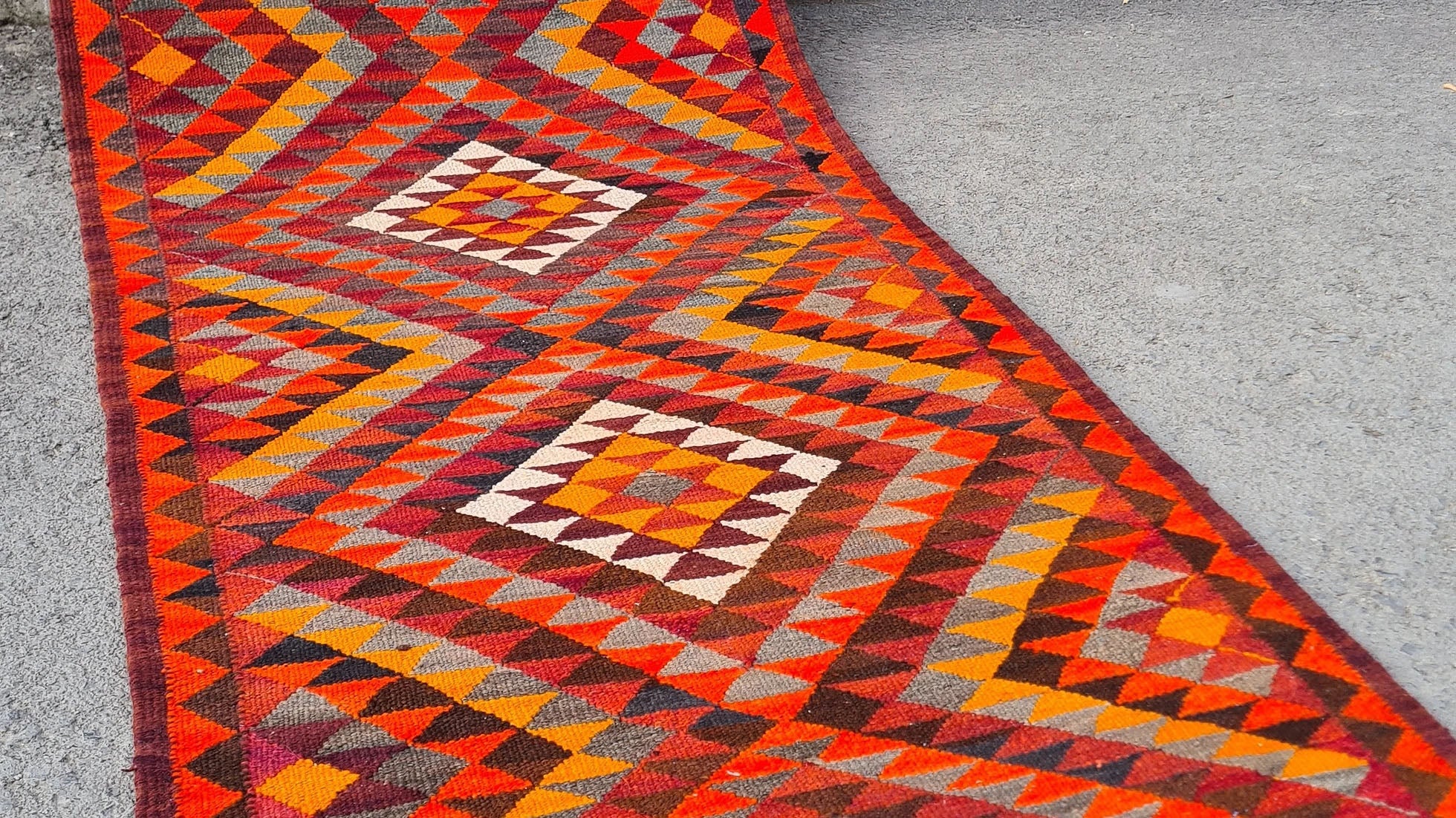 Artisan-made Afghan runner, 3x12 ft, featuring a bold diamond flat-weave design in vermilion red, persimmon orange, and ochre yellow. Durable and versatile, ideal for hallways, kitchens, or entryways, blending tradition with modern style.