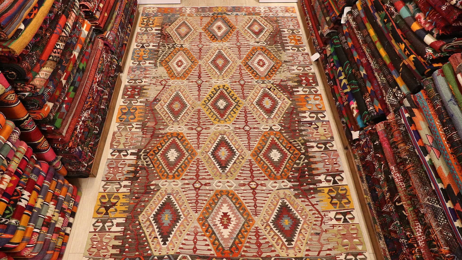 vintage handwoven Turkish rustic kilim rug in muted neutral hues and tribal motifs by Kilim Couture New York rug gallery