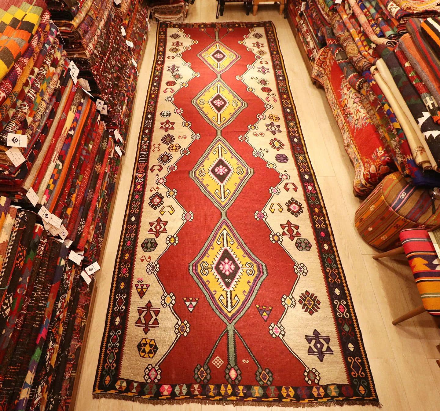 vintage gorgeous kars medallion runner rug showcasing many traditional Anatolian patterns and motifs in earthy and vibrant colors
