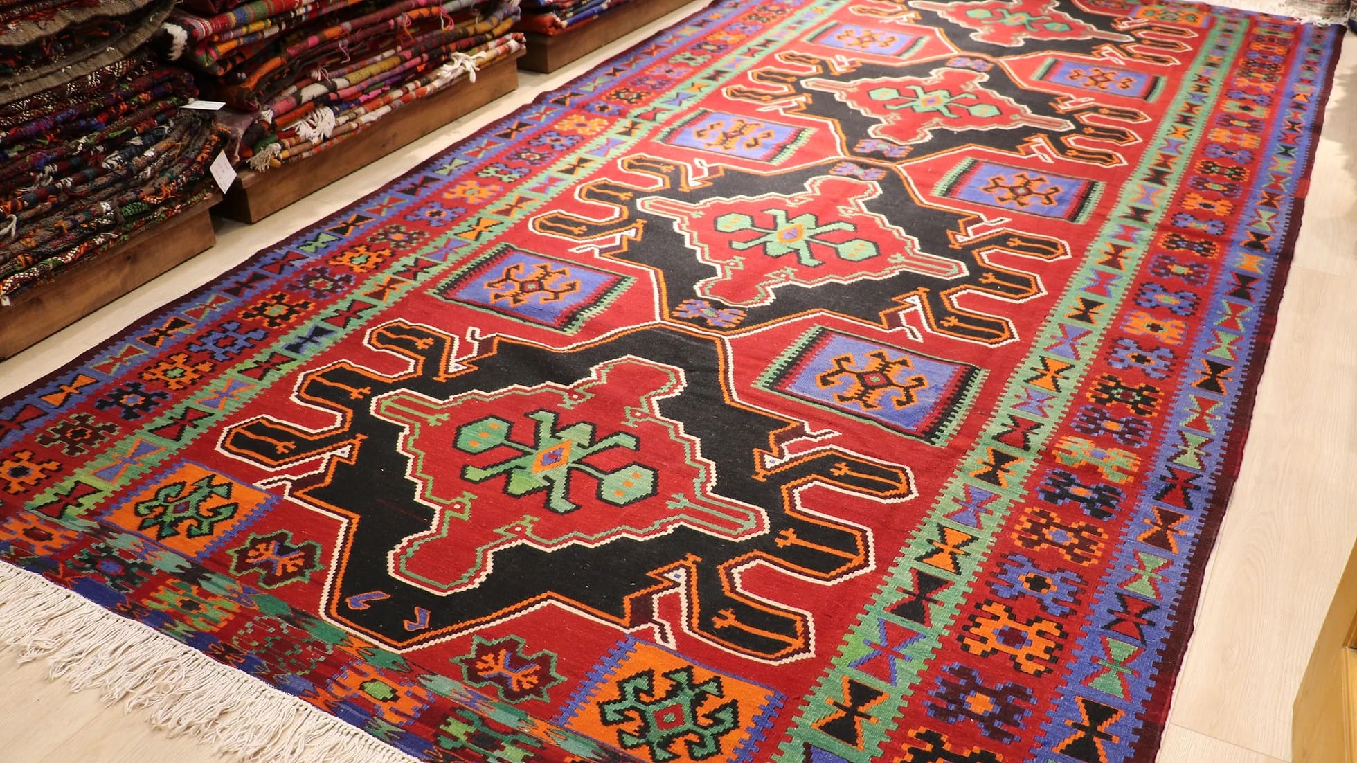 very fine and rare Caucasian gallery runner rug showcasing many traditional motifs and charming geometric medallion patterns in red, black, green, and blue