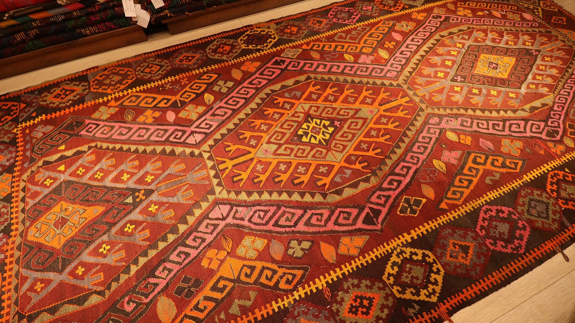 vintage handwoven Ushak oriental rug in rustic colors and tribal motifs