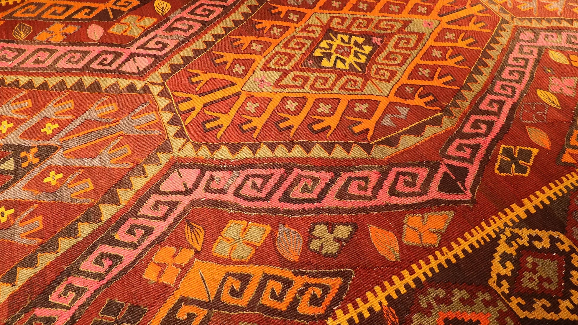 vintage handwoven Ushak oriental rug in rustic colors and tribal motifs
