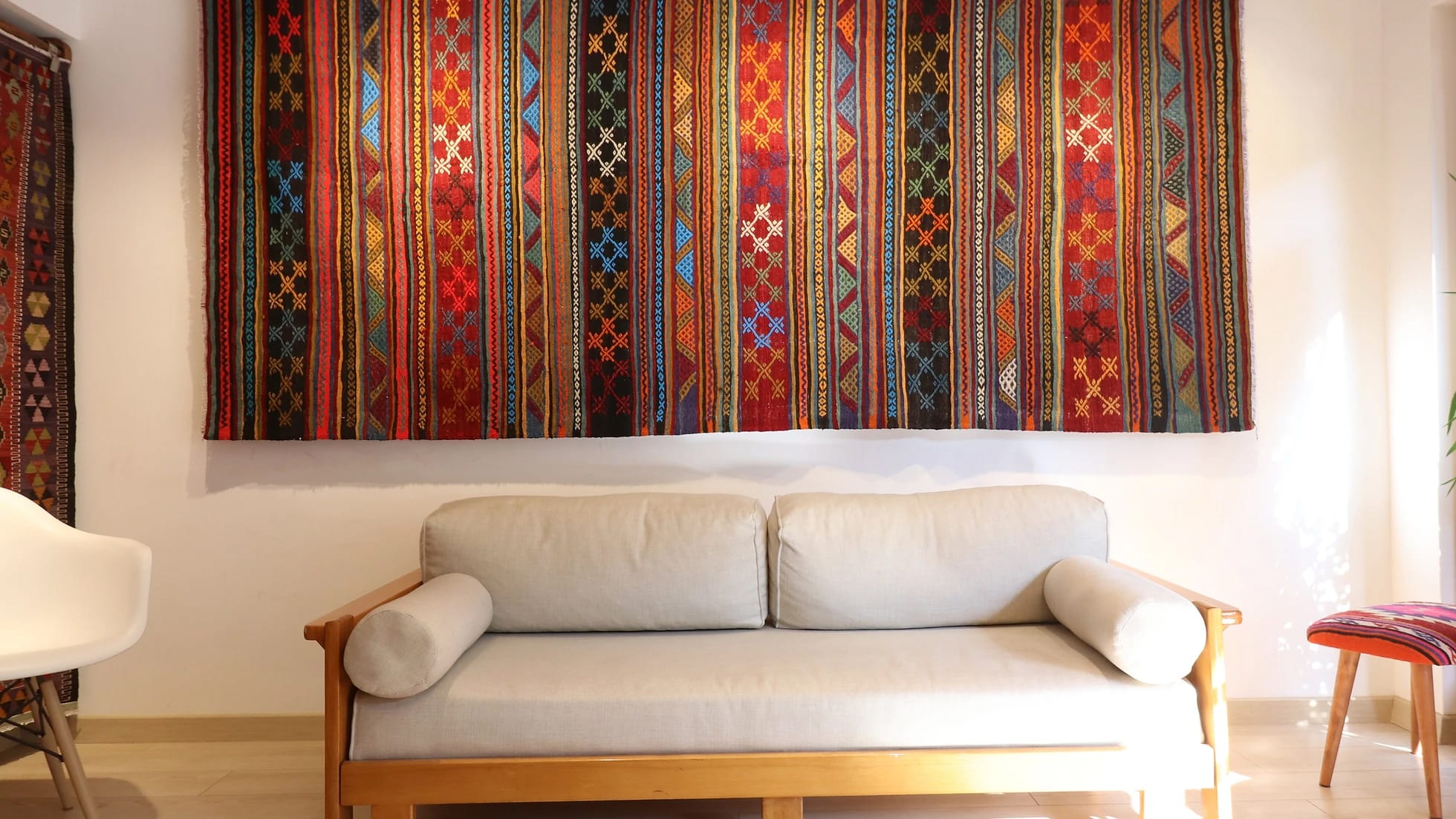 vintage rustic syle handwoven Turkish flat-weave rug in earthy tones on the wall