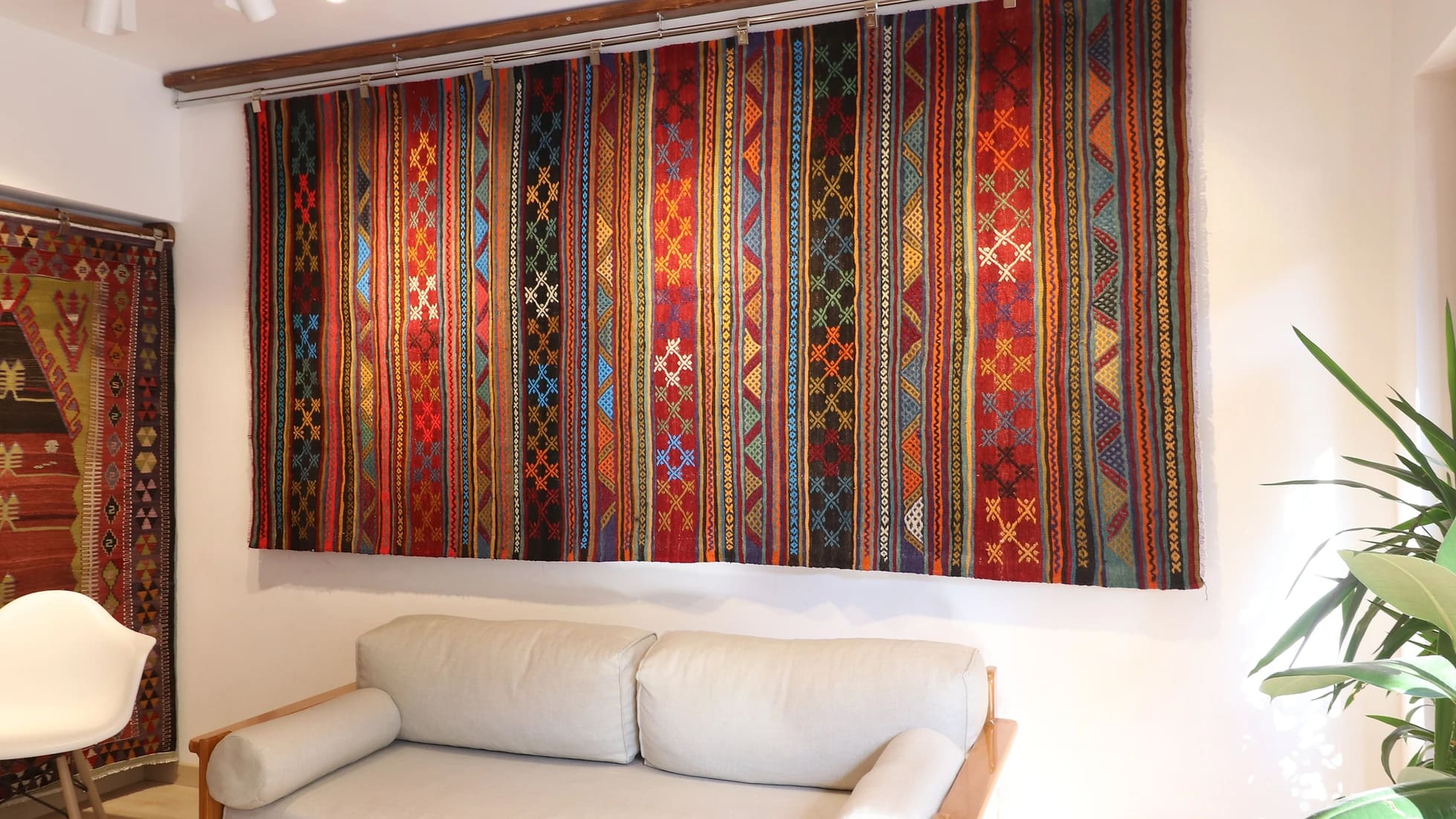 vintage rustic syle handwoven Turkish flat-weave rug in earthy tones on the wall