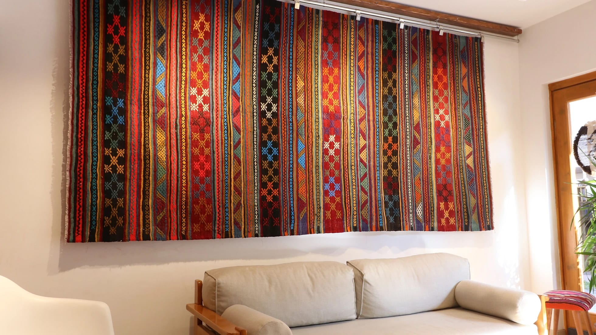 vintage rustic syle handwoven Turkish flat-weave rug in earthy tones on the wall