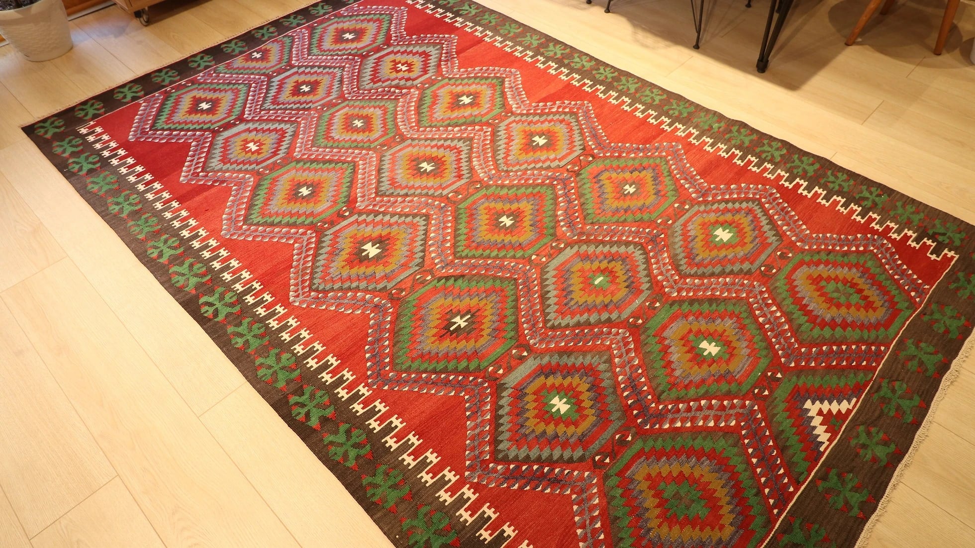 transitional and eclectic premium Oushak Esme rug is displayed in a beautiful living room in detail