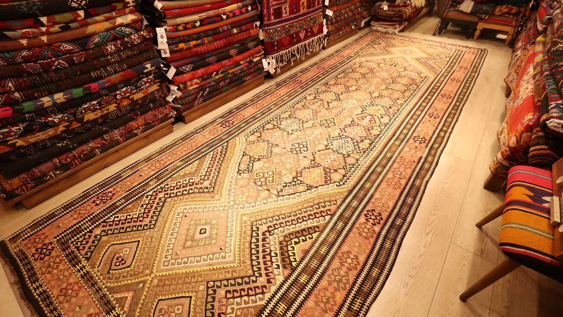 traditional Oushak runner kilim rug is displayed in a rug store in NYC