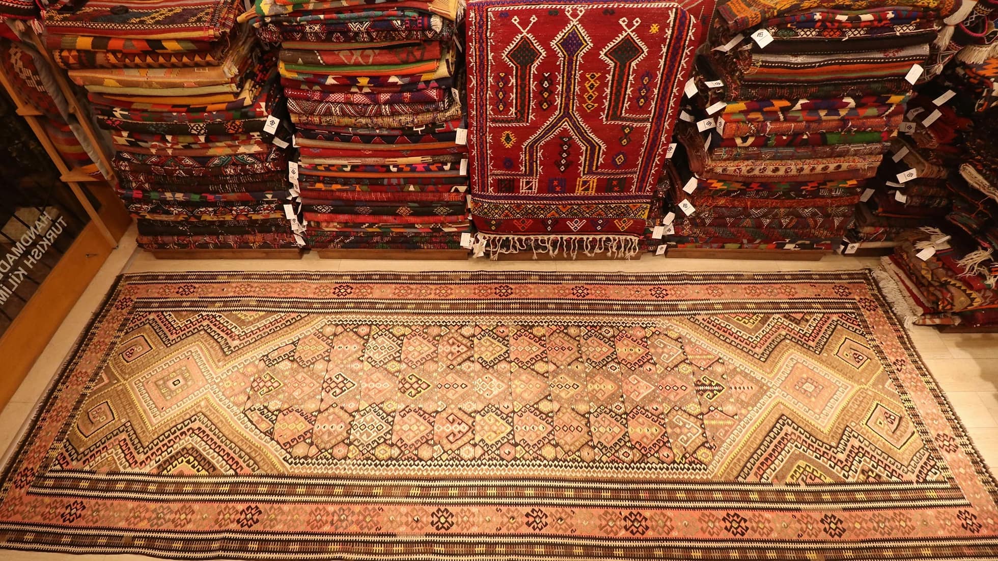 traditional Oushak runner kilim rug is displayed in a rug store in NYC