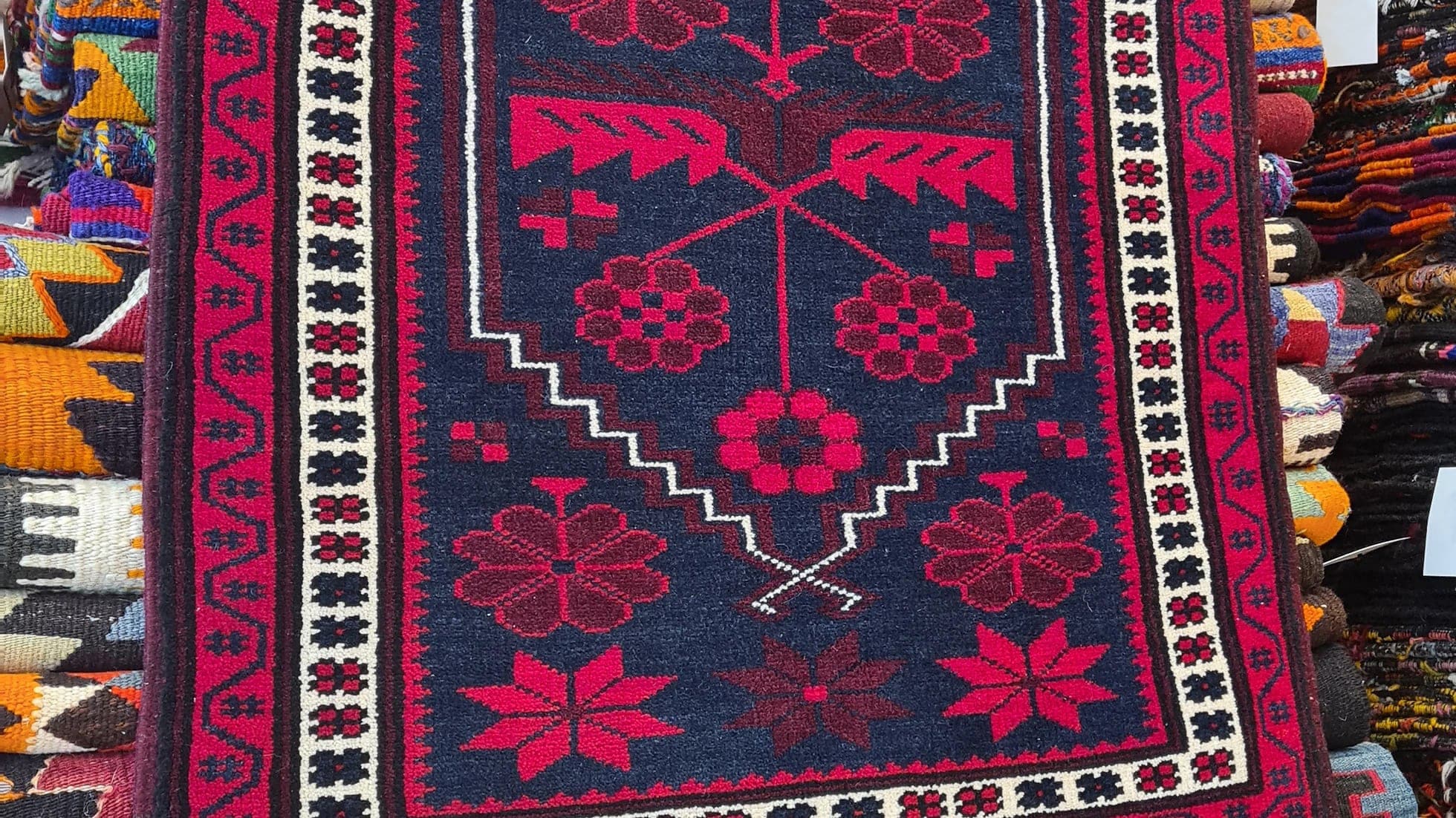 vintage balikesir yagcibedir floral carpet in red and navy hues inside our rug store in NYC