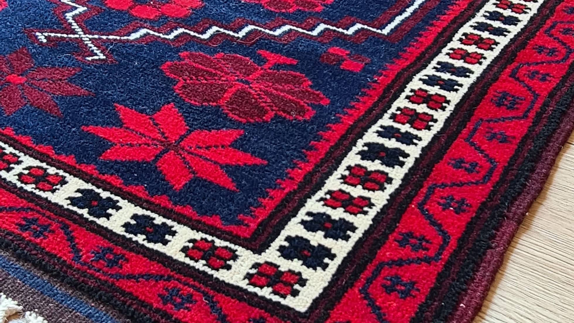 vintage balikesir yagcibedir floral carpet in red and navy hues inside our rug store in NYC